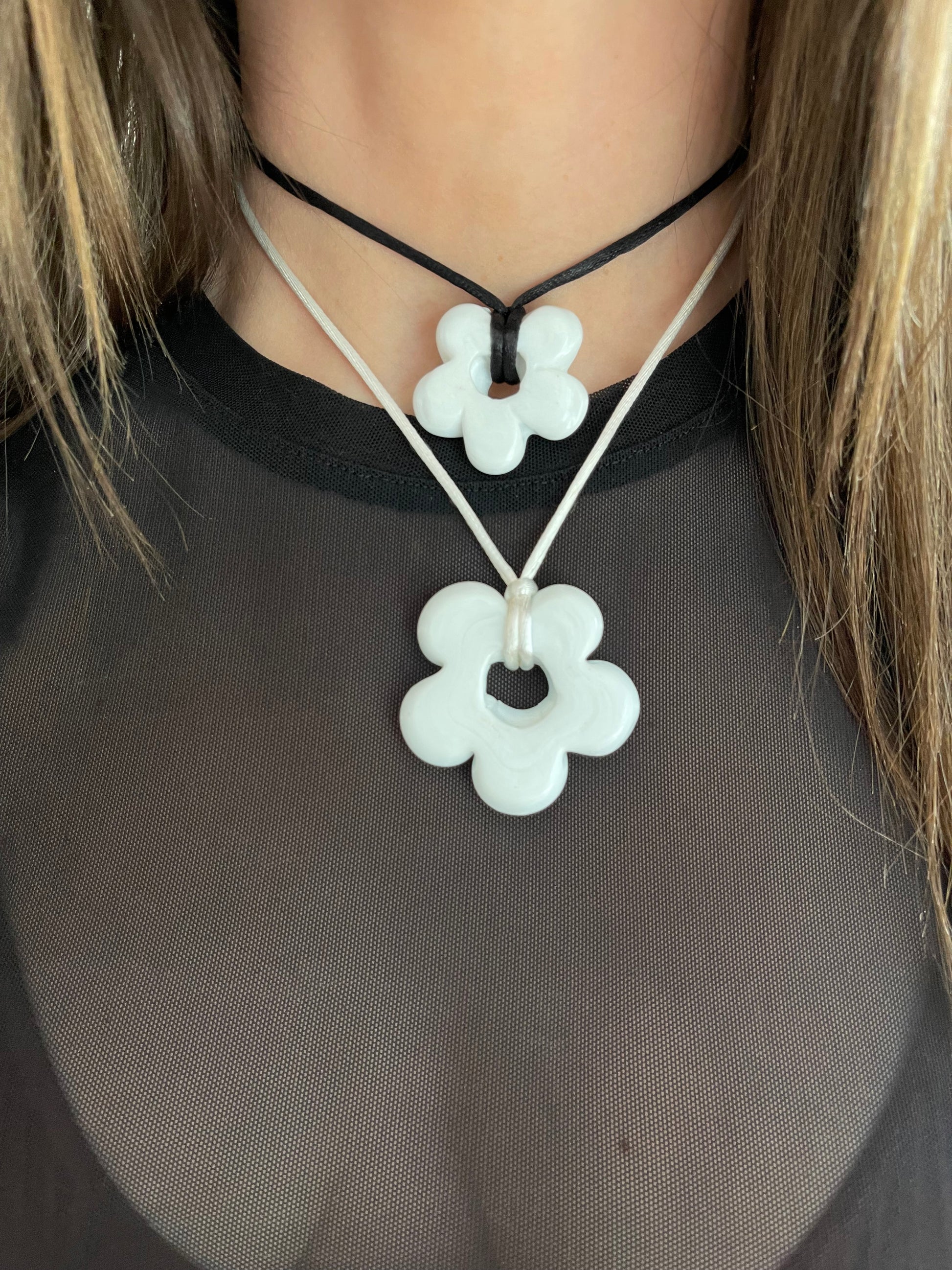 On Top: Medium Himalaya White FLower with black cord